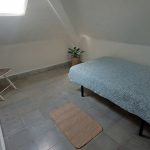Simple small bedroom with single bed, skylight, and minimal decor at Nordés Surfhouse in Ferrol Galicia