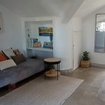Cozy living room with sofa, books, and decor in Nordés Surfhouse surf accommodation Ferrol Galicia